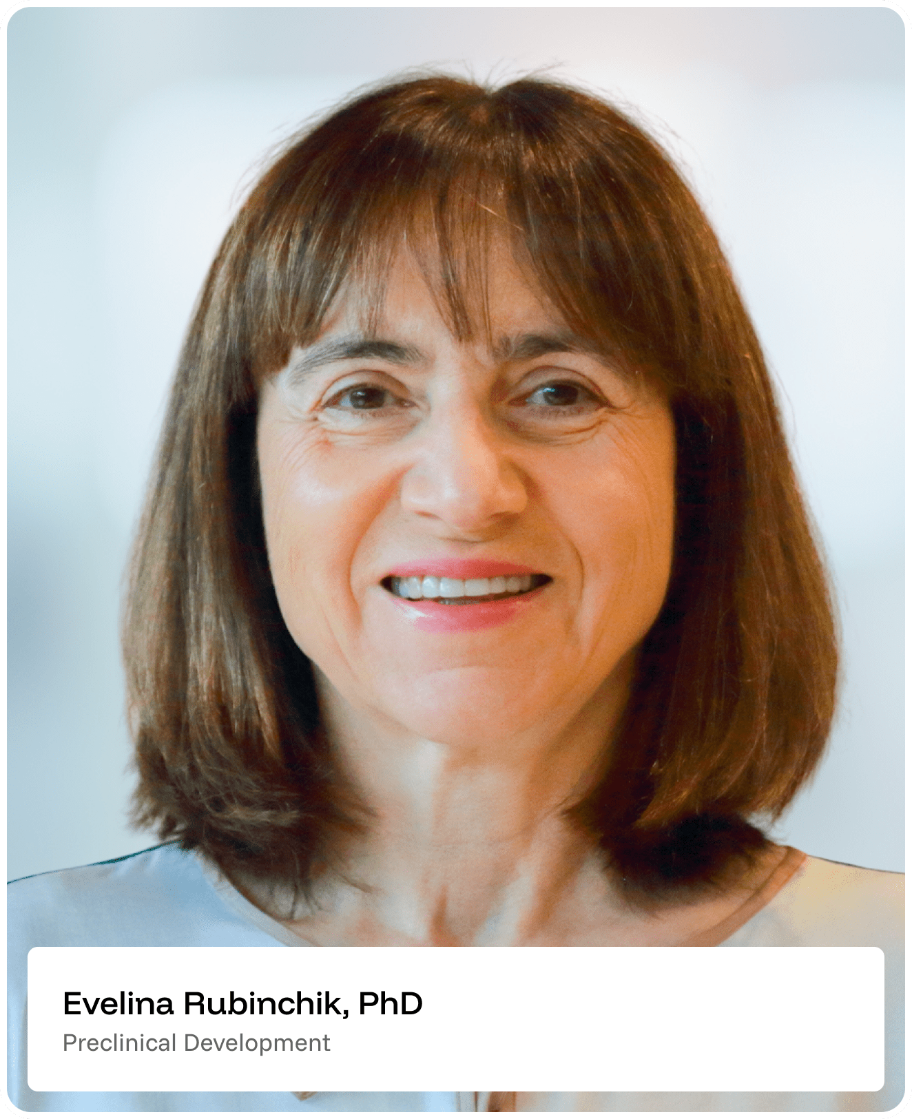 A woman with straight brown hair and bangs smiles at the camera. She is wearing a light-colored top. Text below reads: Evelina Rubinchik, PhD, Preclinical Development..