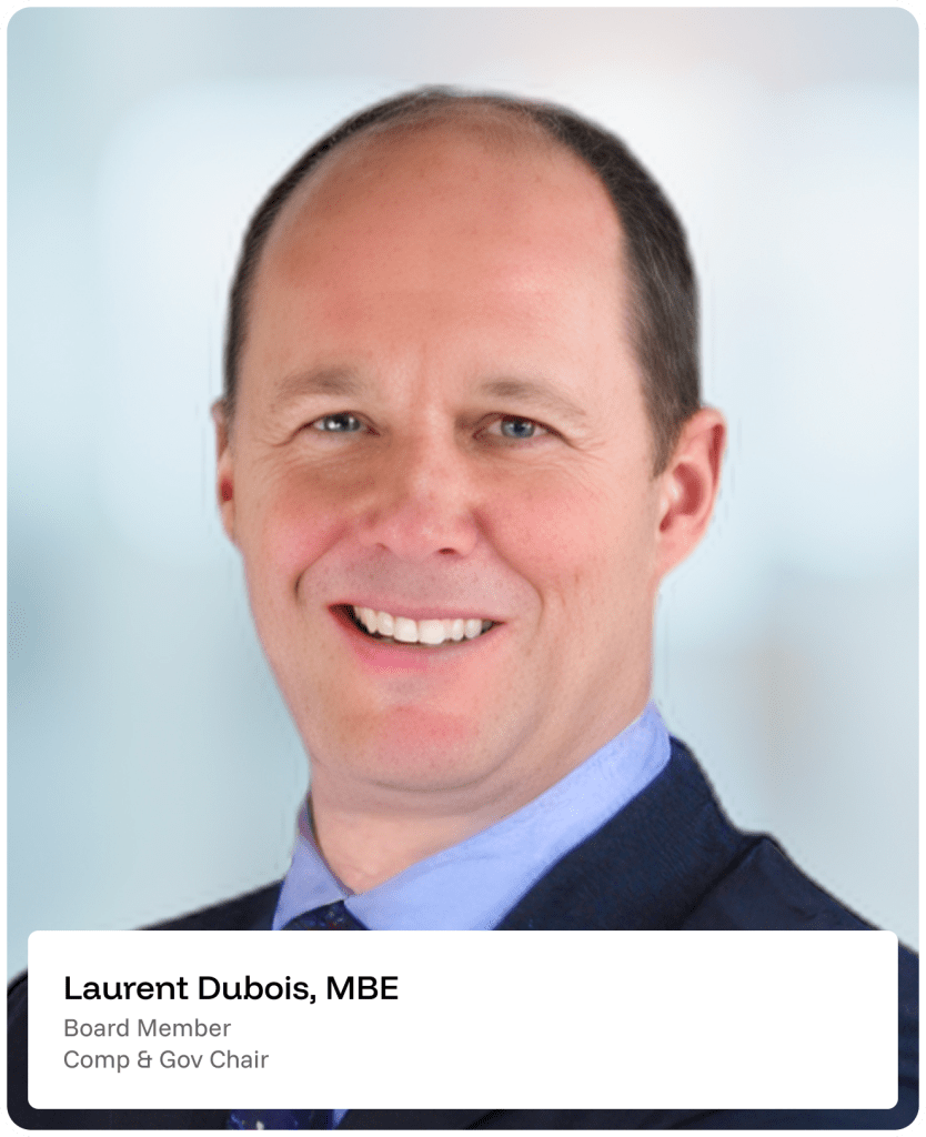 A man in a suit smiles at the camera. Text box reads: Laurent Dubois, MBE. Board Member. Comp & Gov Chair. The background is softly blurred blue and white.