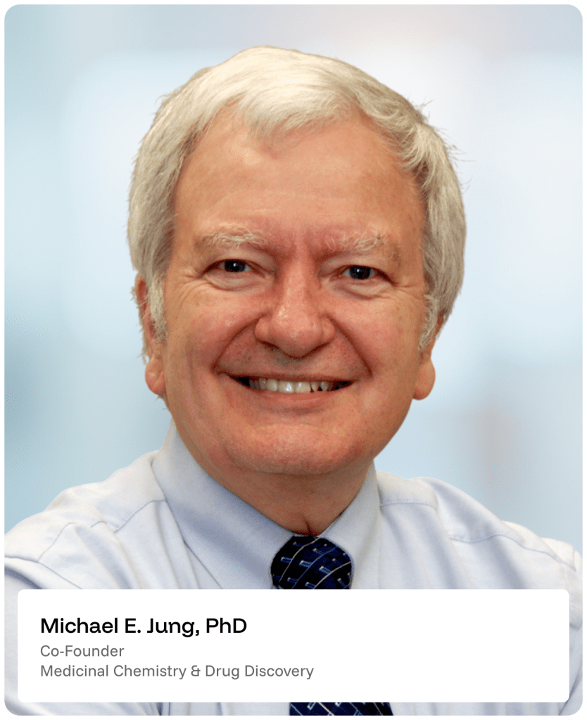 Smiling older man with gray hair in a light blue shirt and navy tie, shown from the shoulders up against a blurred background. Text overlay reads: Michael E. Jung, PhD, Co-Founder, Medicinal Chemistry & Drug Discovery.