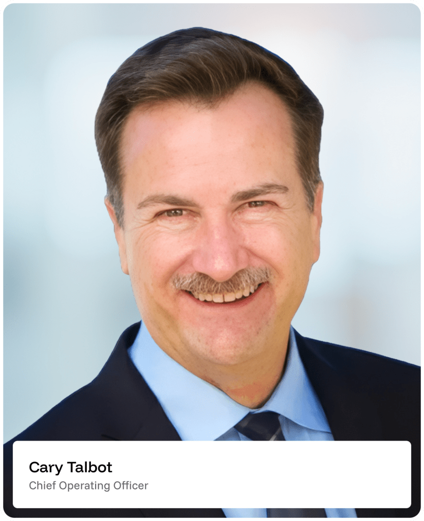 Smiling man with brown hair and mustache in a suit and tie, shown against a blurred light background. Text on image: Cary Talbot, Chief Operating Officer..